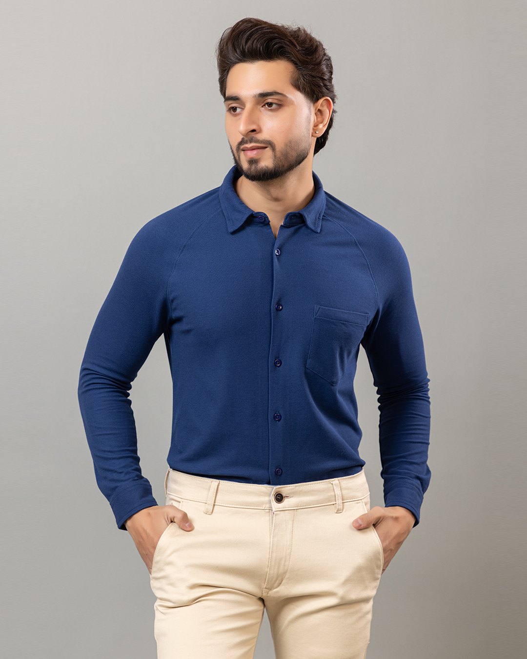 Model wearing a Habeas royal blue full sleeve honeycomb knit shirt